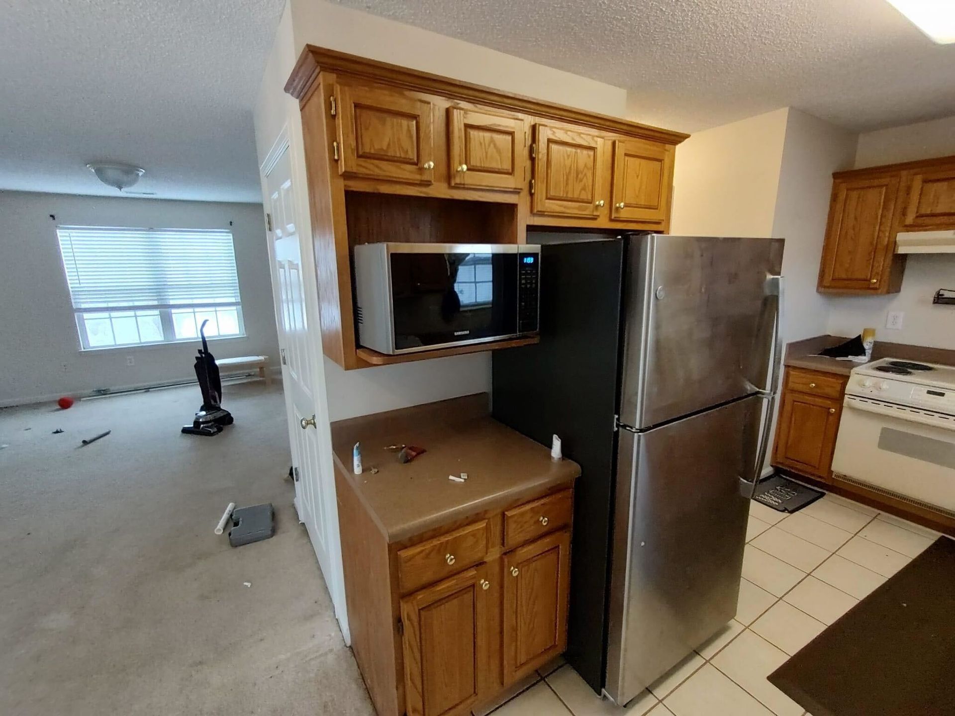 A kitchen with stainless steel appliances and wooden cabinets