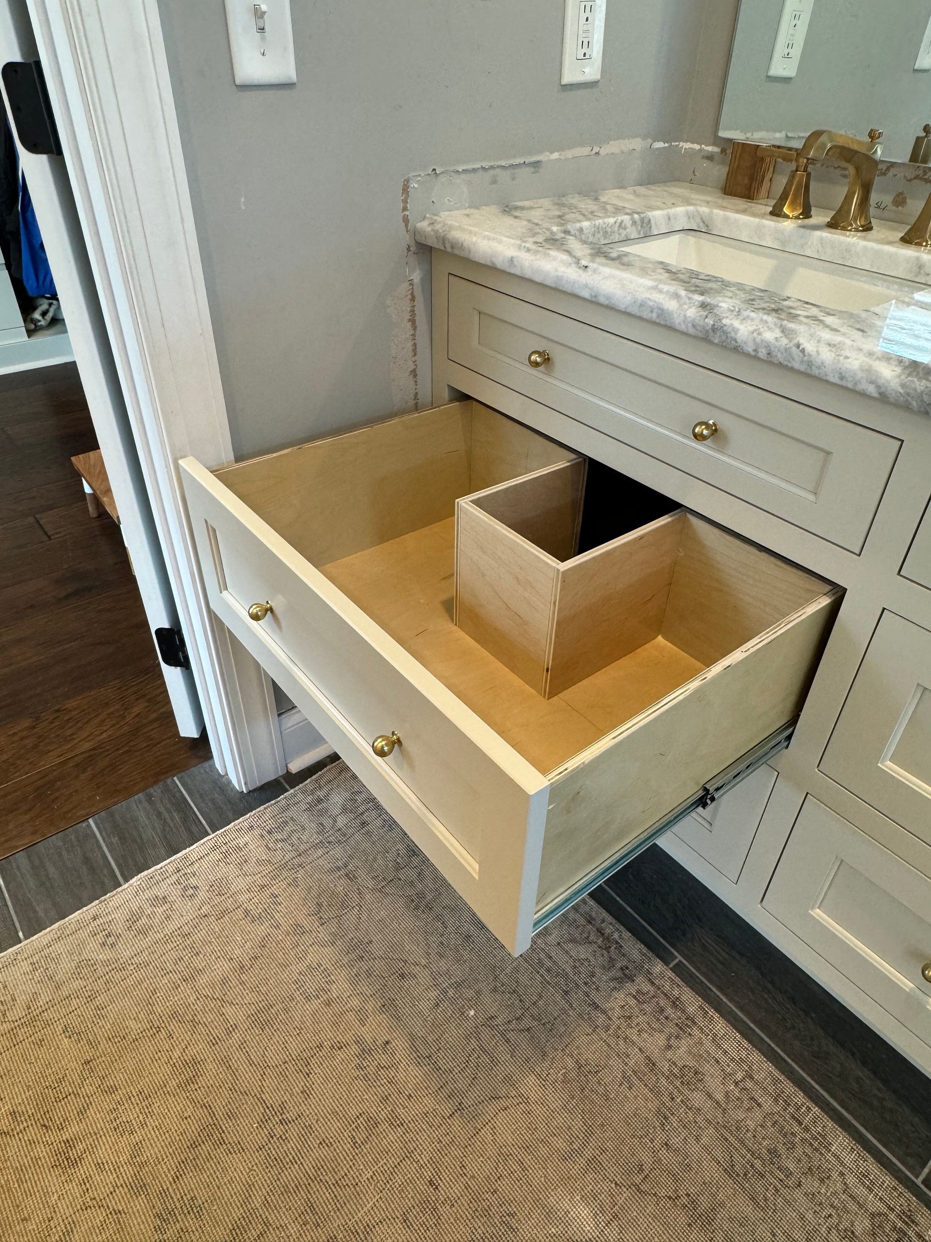 A bathroom vanity with a drawer that is open