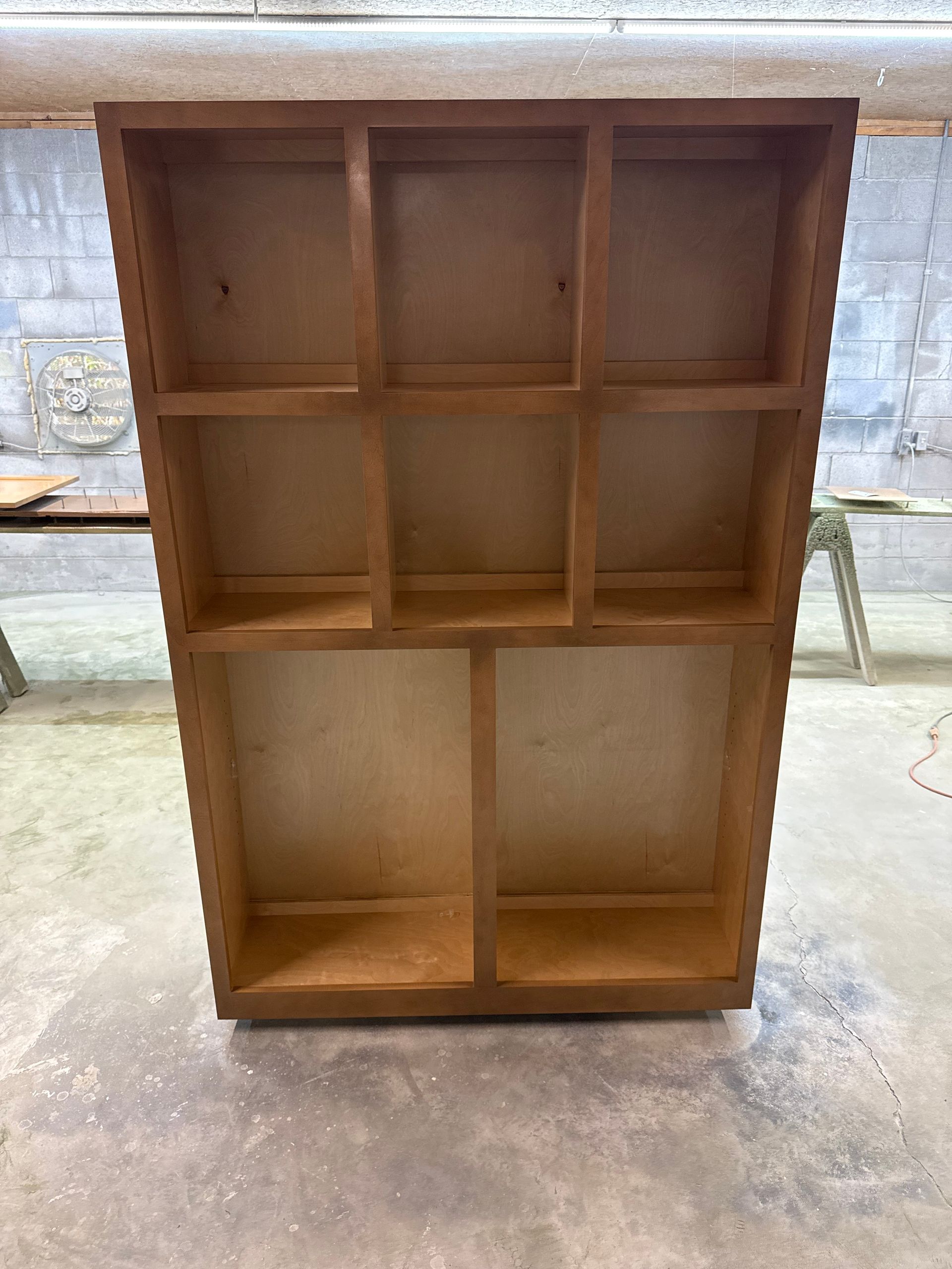 Empty wooden cabinet with seven compartments.