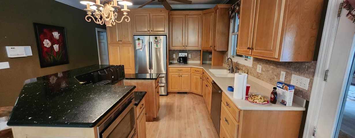 A kitchen with wooden cabinets and stainless steel appliances.