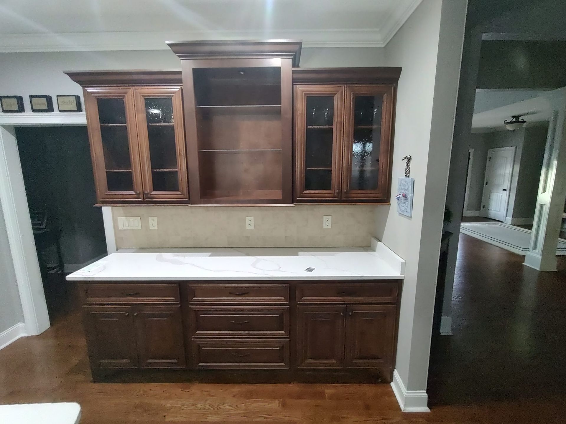 A kitchen with wooden cabinets and a white counter top