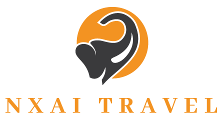 Logo for Nxai Travel featuring a black elephant silhouette inside an orange circle above the text 