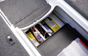 Batteries in a boat storage compartment, with wiring visible.