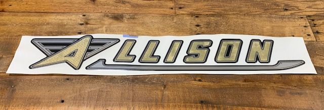 Allison decal on a wood surface. The logo is gold with a gray outline.
