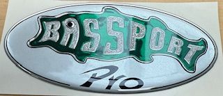 Bass sport Pro emblem with a green fish, silver letters, and chrome oval.