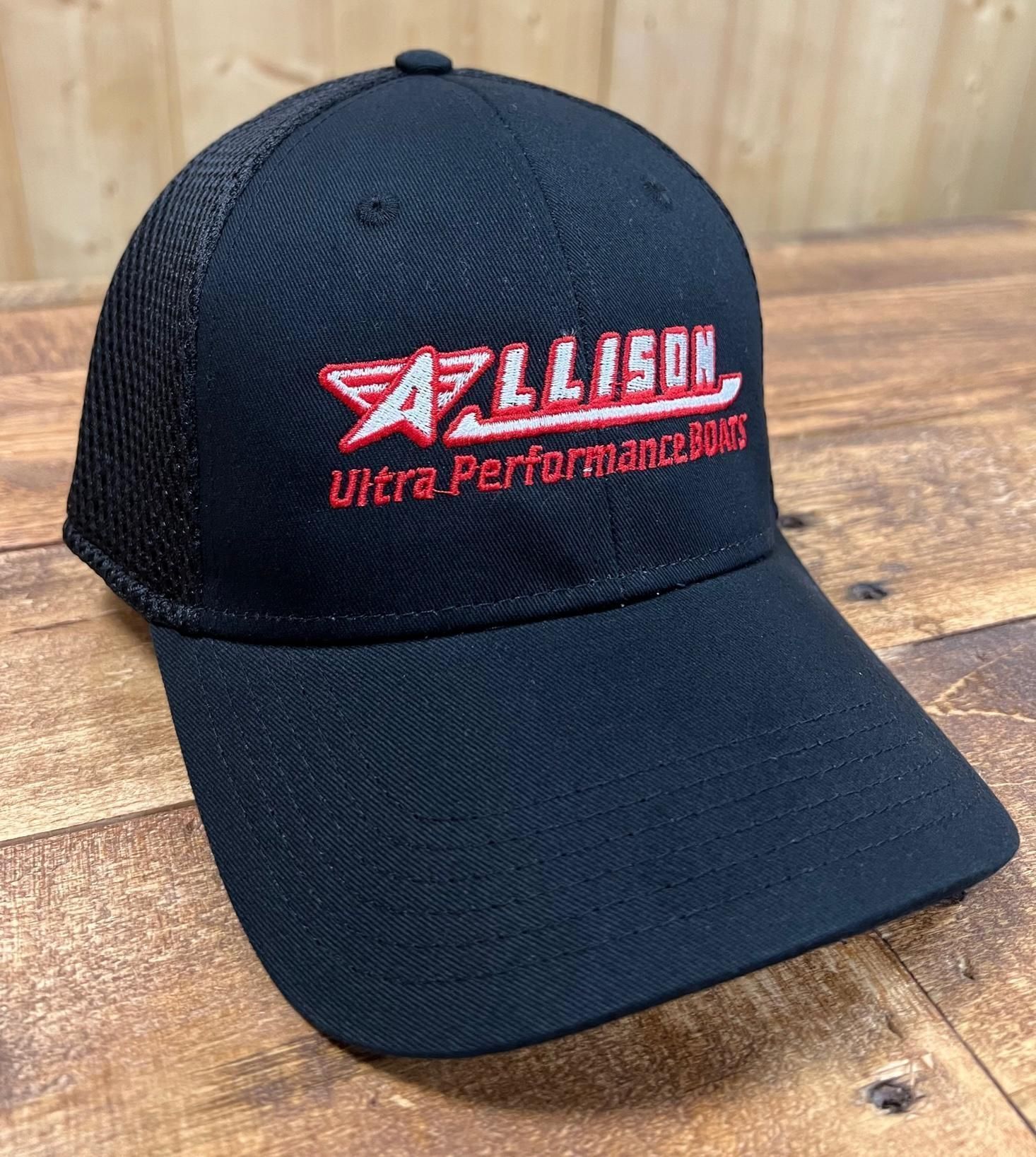 Black Allison trucker hat with red logo on wooden surface.