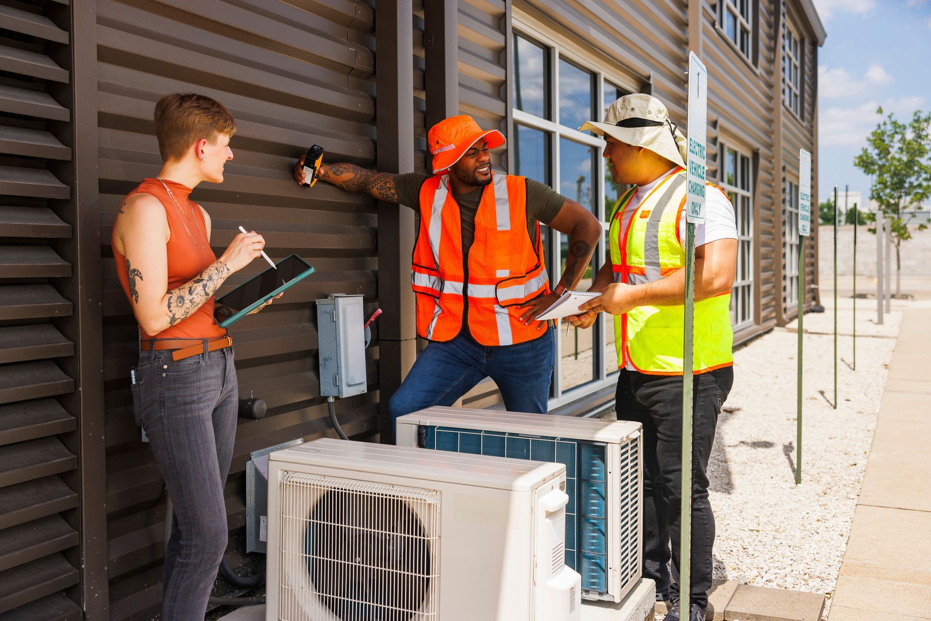 Diverse team of engineers evaluates air conditioning system.