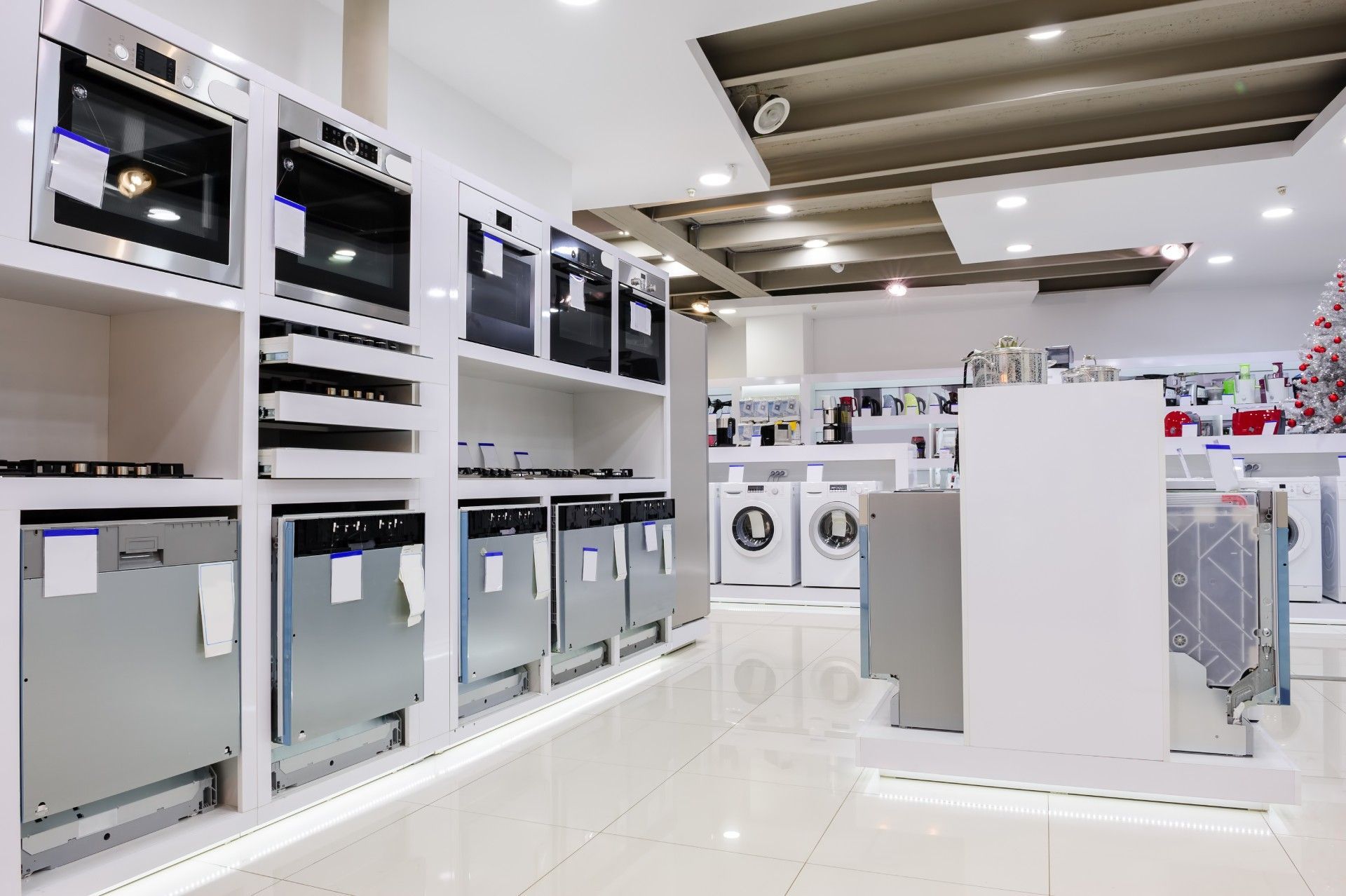 A store filled with lots of appliances including a washing machine and a dishwasher.