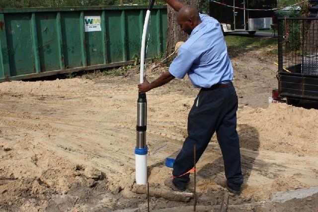 A Man Installing Water Well — South Bend, IN — Maurer Well & Pump Service Inc