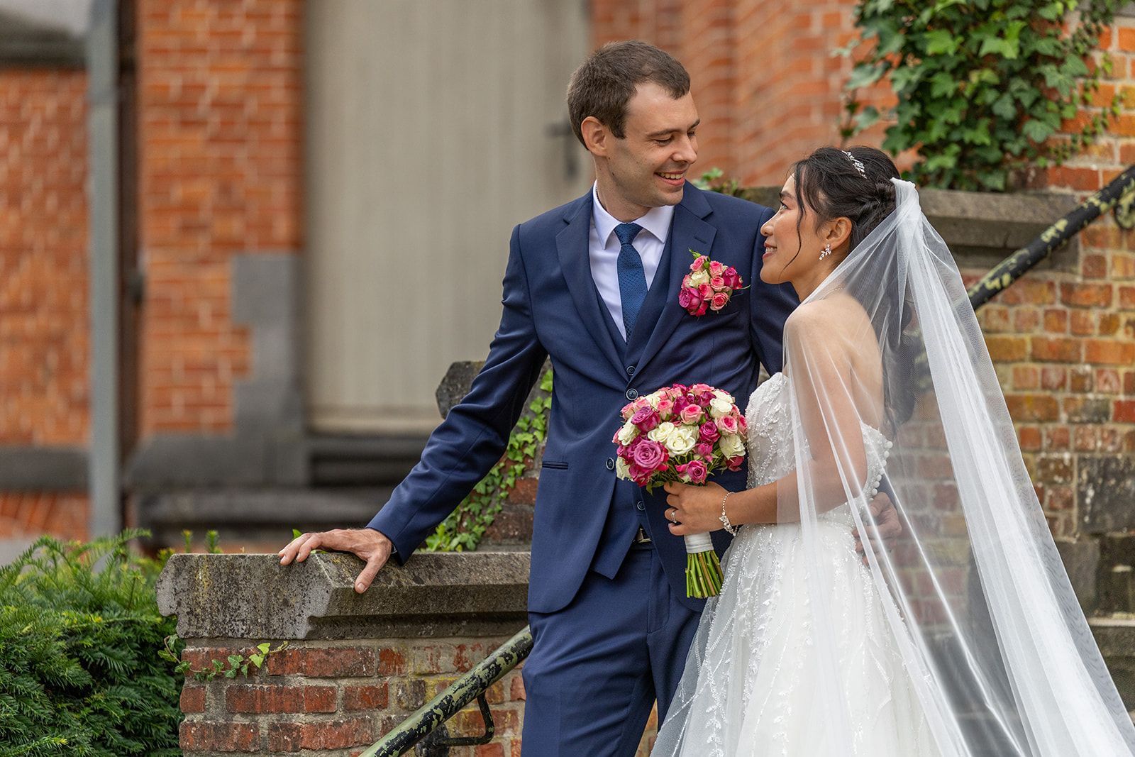 Trouwringen in het midden van een lichtroze, crèmekleurige bloem.