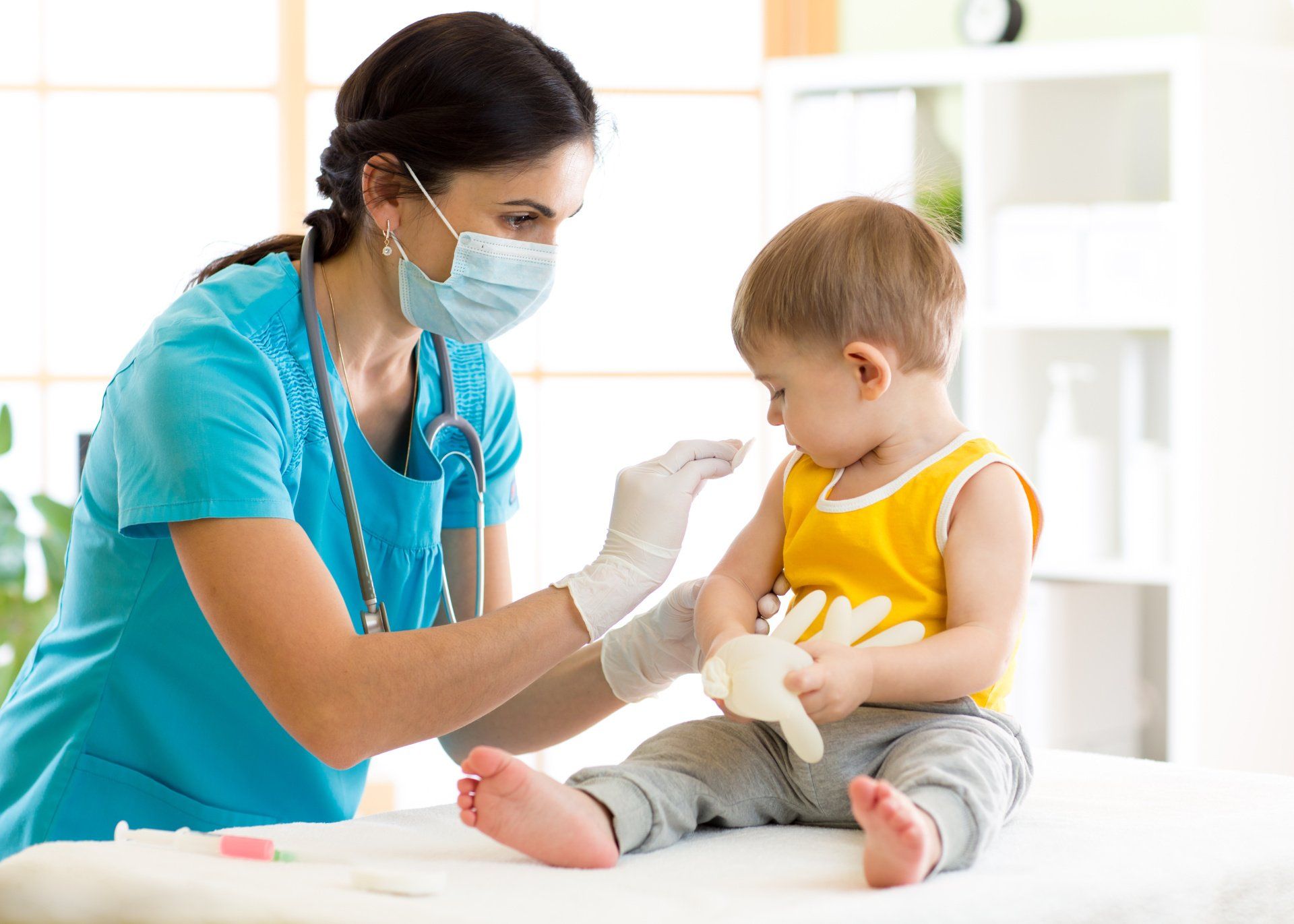 pediatric nurse gives toddler a vaccine