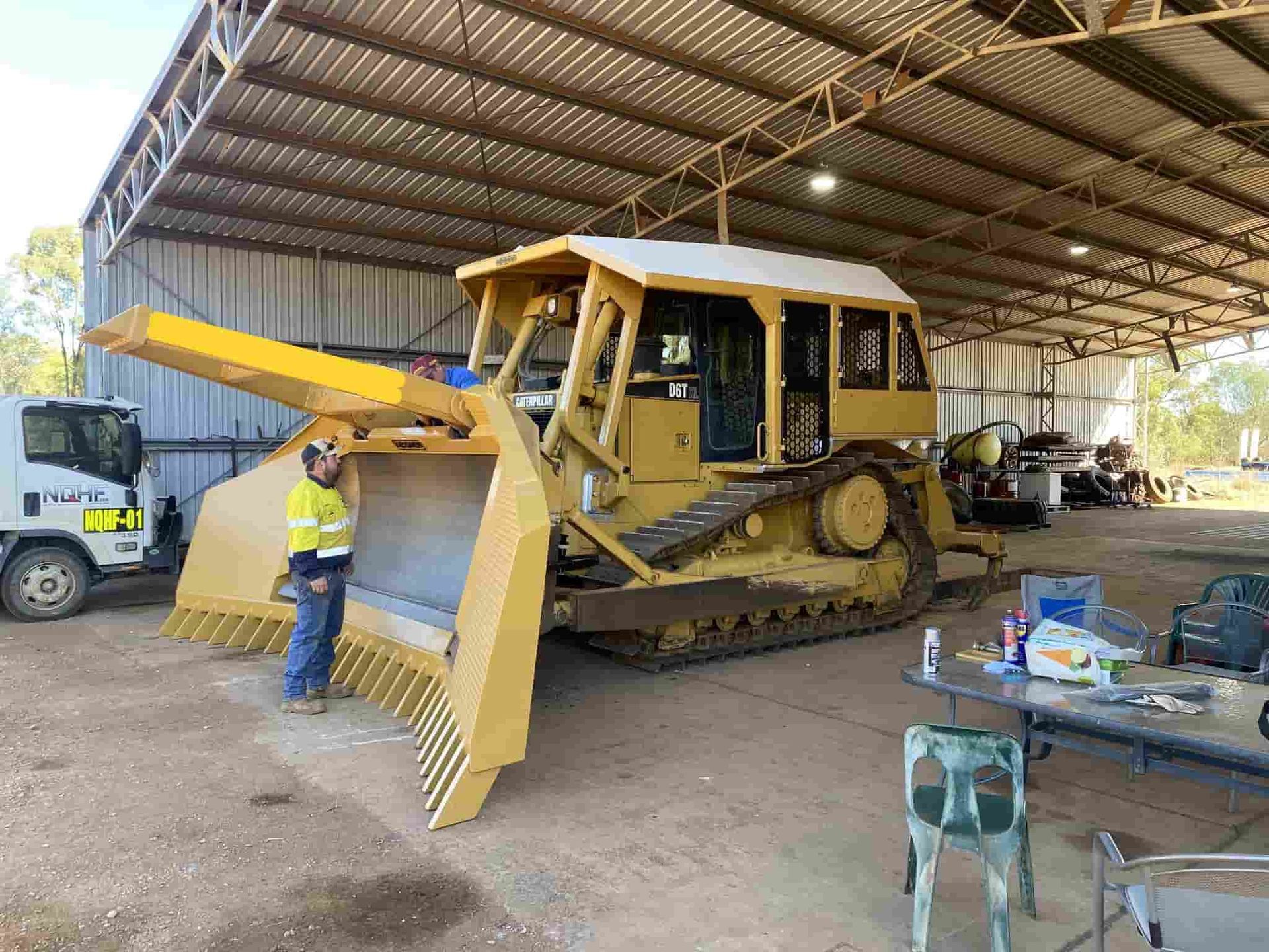 A Bunch of Metal Pipes Are Stacked on Top of Each Other — North Queensland Hard Facing (NQHF) In Hunter Valley, NSW