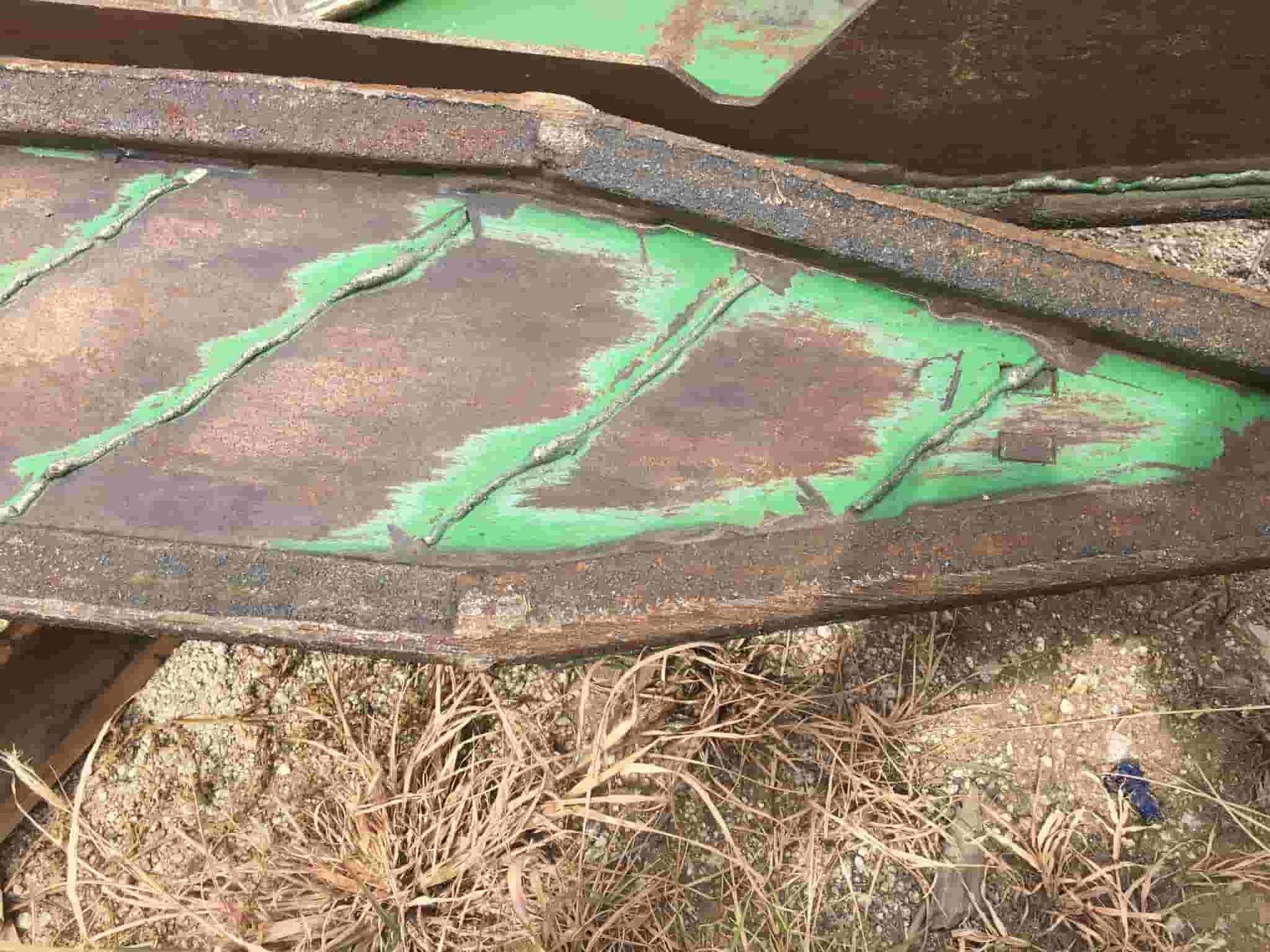 A Close Up of a Piece of Metal With Green Paint on It — North Queensland Hard Facing (NQHF) In Fredericksfield, QLD