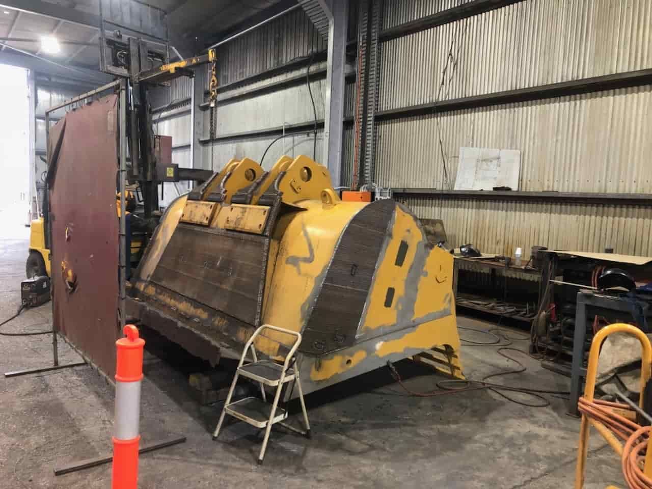 A Large Metal Container is Sitting in a Warehouse — North Queensland Hard Facing (NQHF) In Collinsville, QLD