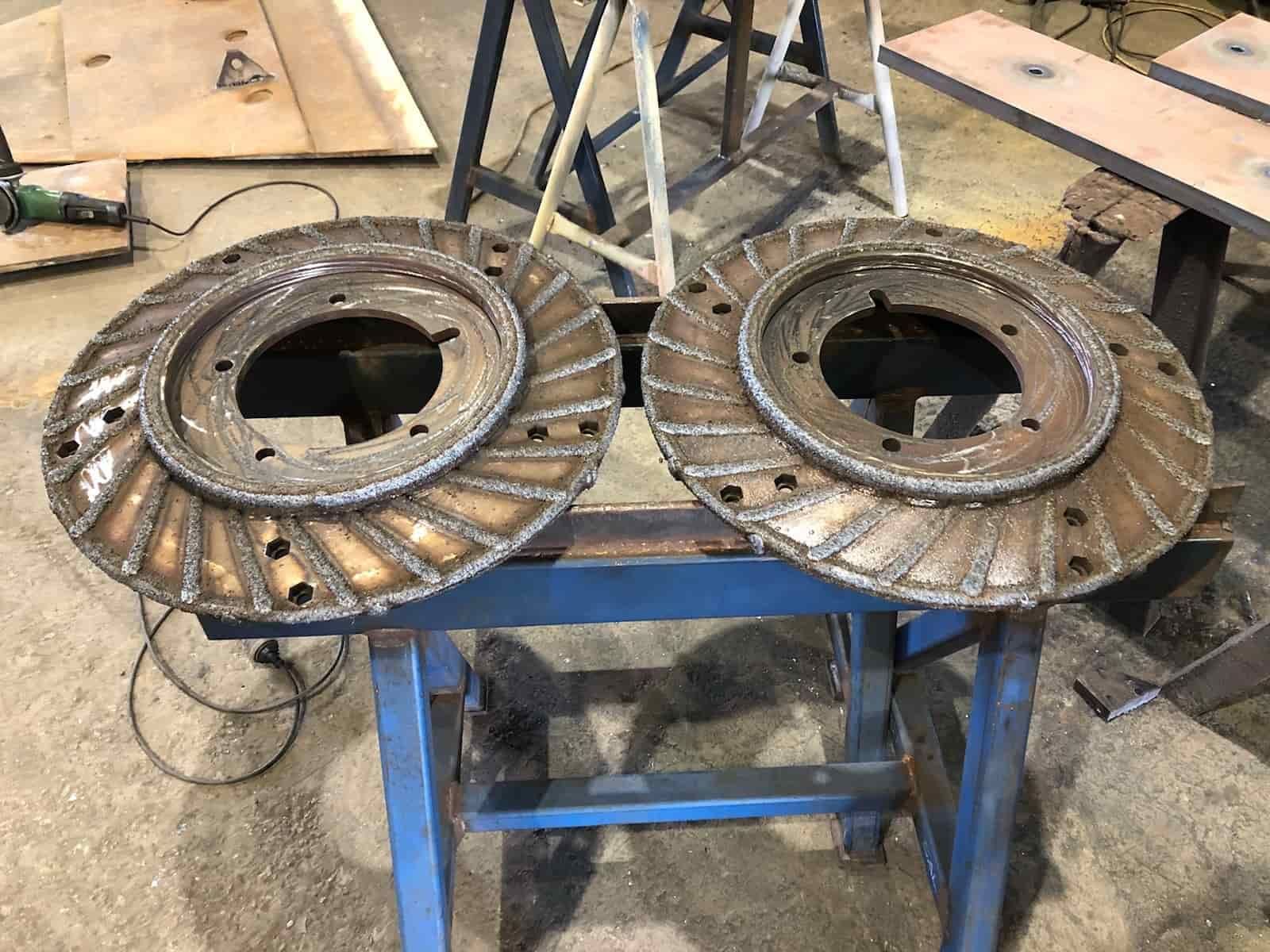 Two Metal Discs Are Sitting on Top of a Blue Table — North Queensland Hard Facing (NQHF) In Mackay, QLD
