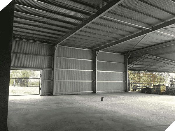 A Large Empty Warehouse With a Concrete Floor and a Metal Roof — North Queensland Hard Facing (NQHF) In Fredericksfield, QLD