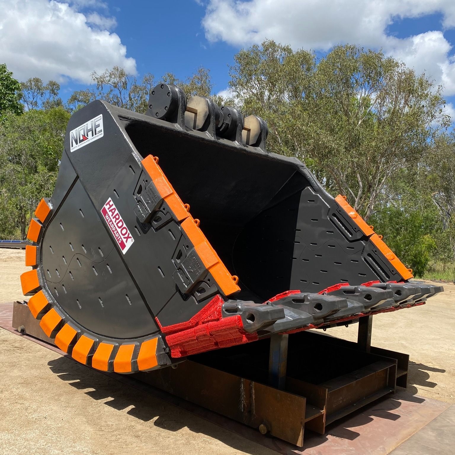 Large Black Excavator Bucket With Orange Teeth and Trim — North Queensland Hard Facing (NQHF) In Fredericksfield, QLD