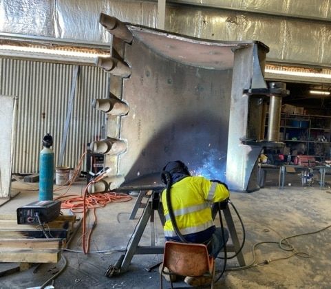 A Bunch of Metal Pipes Are Stacked on Top of Each Other — North Queensland Hard Facing (NQHF) In Hunter Valley, NSW