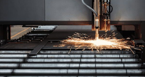 A Machine is Cutting a Piece of Metal — North Queensland Hard Facing (NQHF) In Fredericksfield, QLD