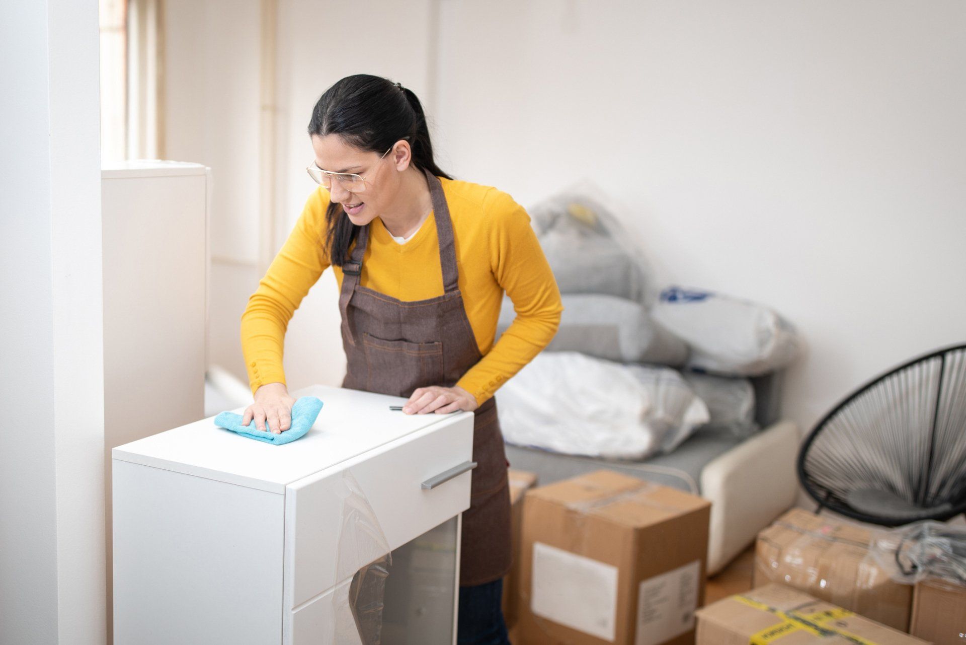 A Woman Cleaning Her Table While Moving In - Dover, OH - Rosmary's Cleaning Service