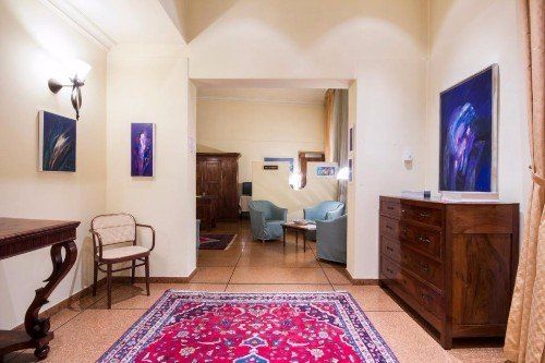 Corridoio dell'hotel, tabelle in tonalità blu e mobili antichi di legno