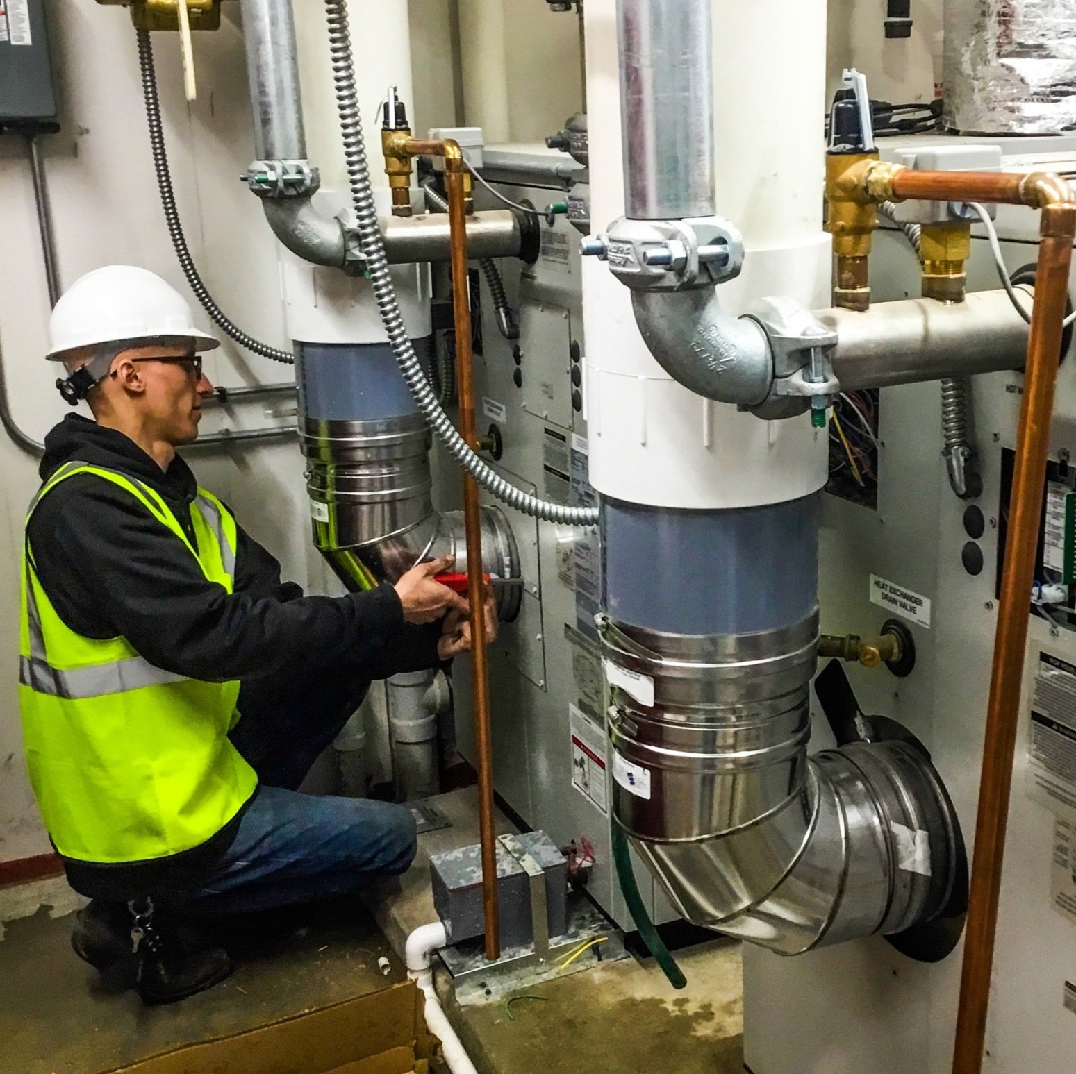 Senior Water Heater Service Technician working on A.O. Smith boiler