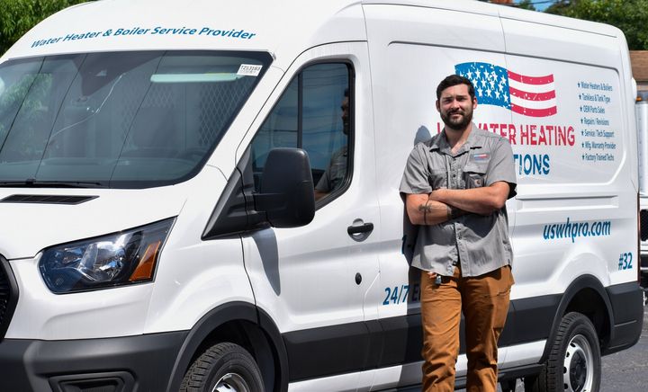 Service technician in company uniform in front of uswhpro truck