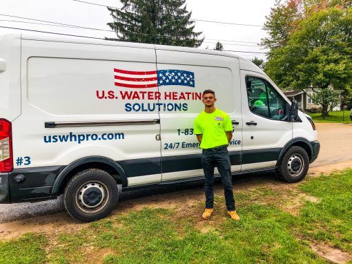 water heater tech in front of truck