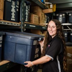 Erin holding commercial water heater parts bin