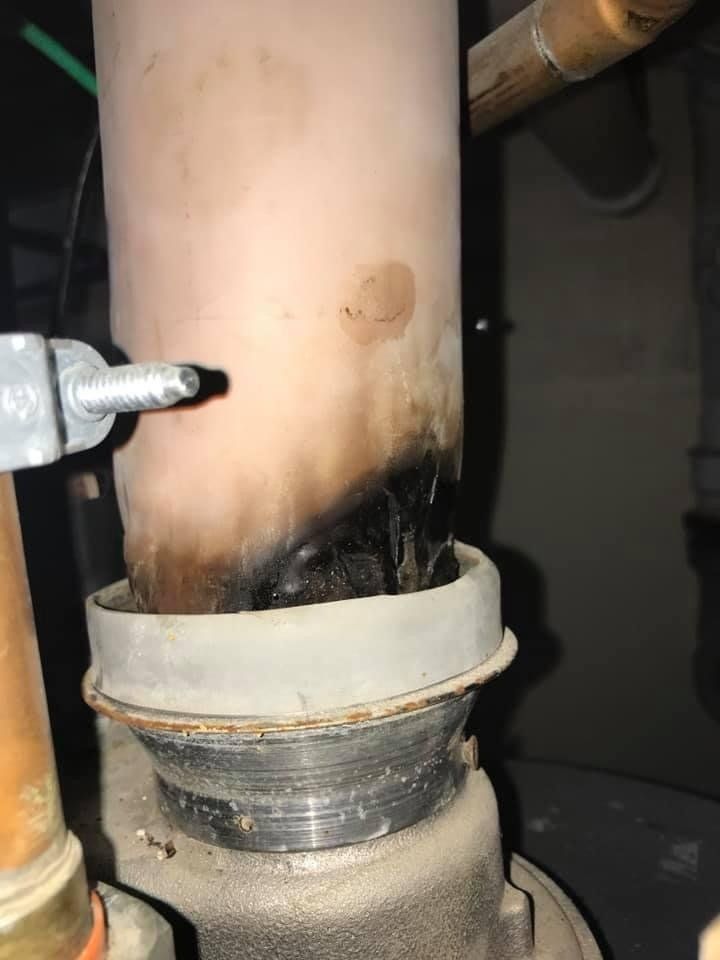 Melted PVC on damper caused by incorrect water heater venting