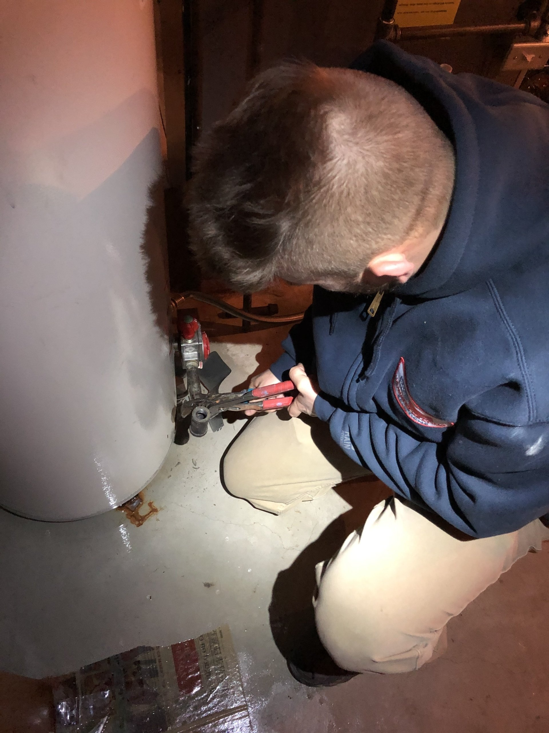 Water Heater Service Technician changing a gas control valve