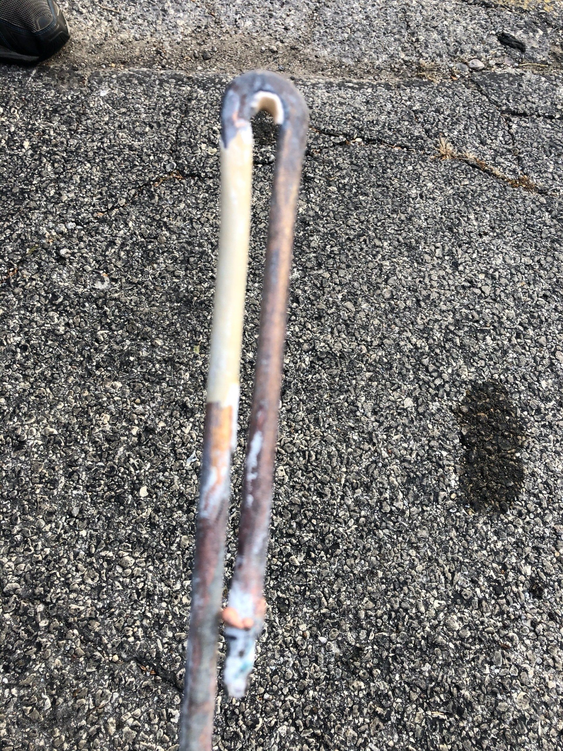 corroded copper water heater element with some sediment build-up