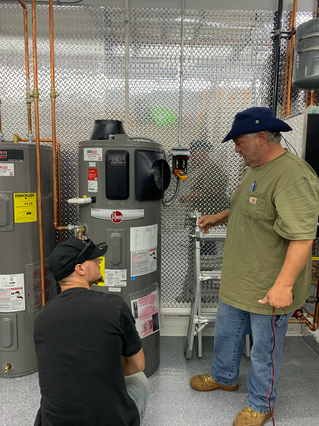 Technician diagnosing hybrid heat pump water heater issue