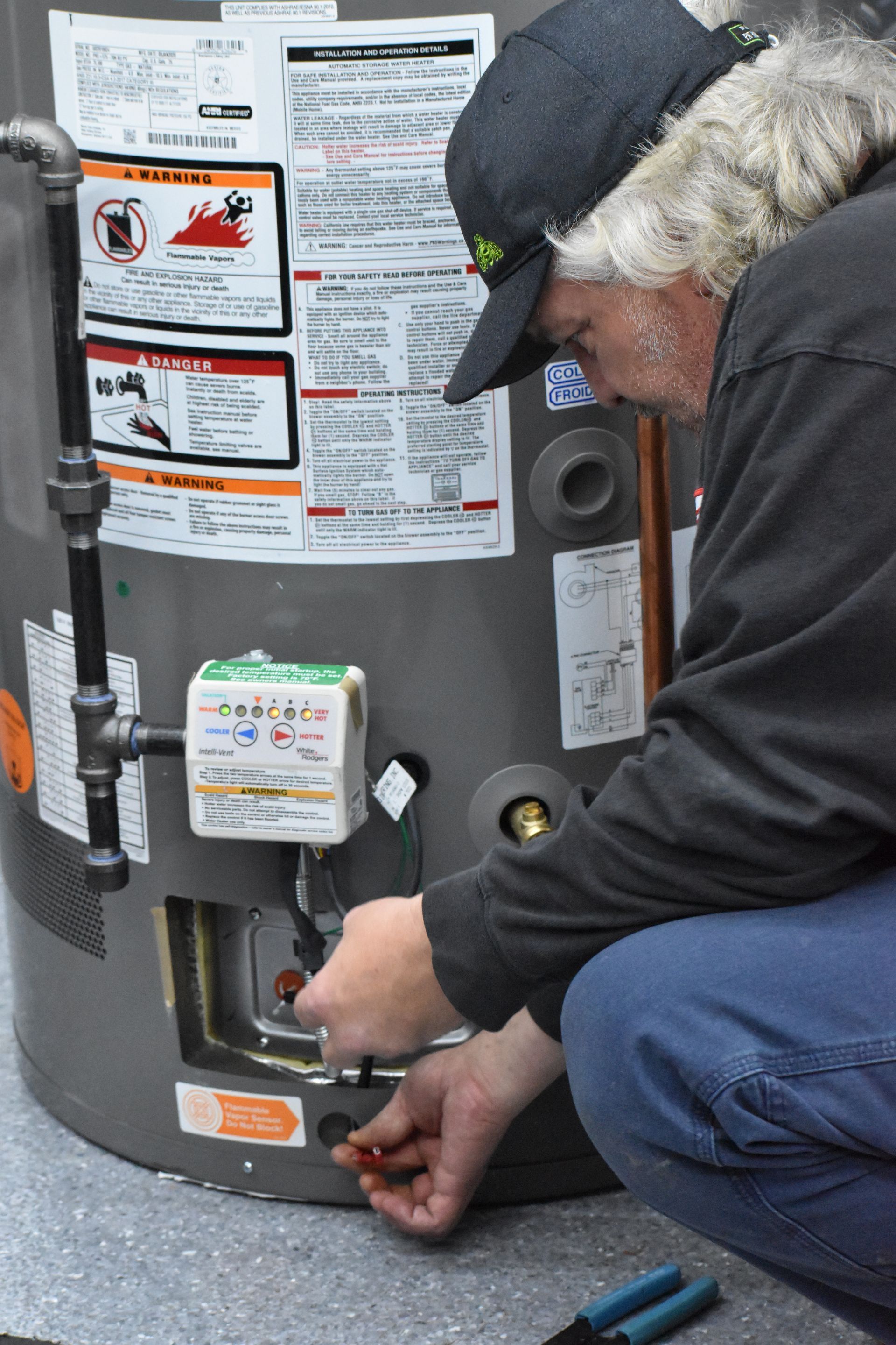 Technician with Gas Valve Showing Error Code and FV Sensor Removed, FV Sensor Harness Showing
