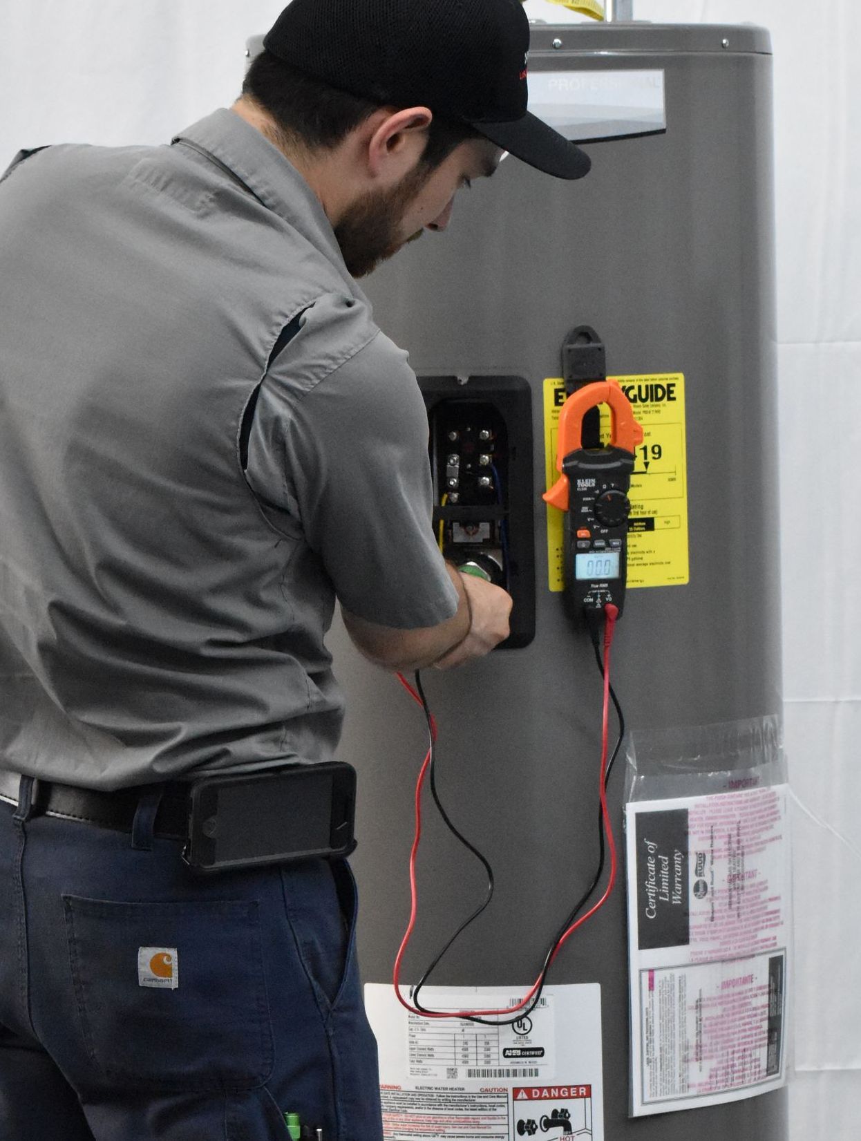 Technician servicing an electric water heater
