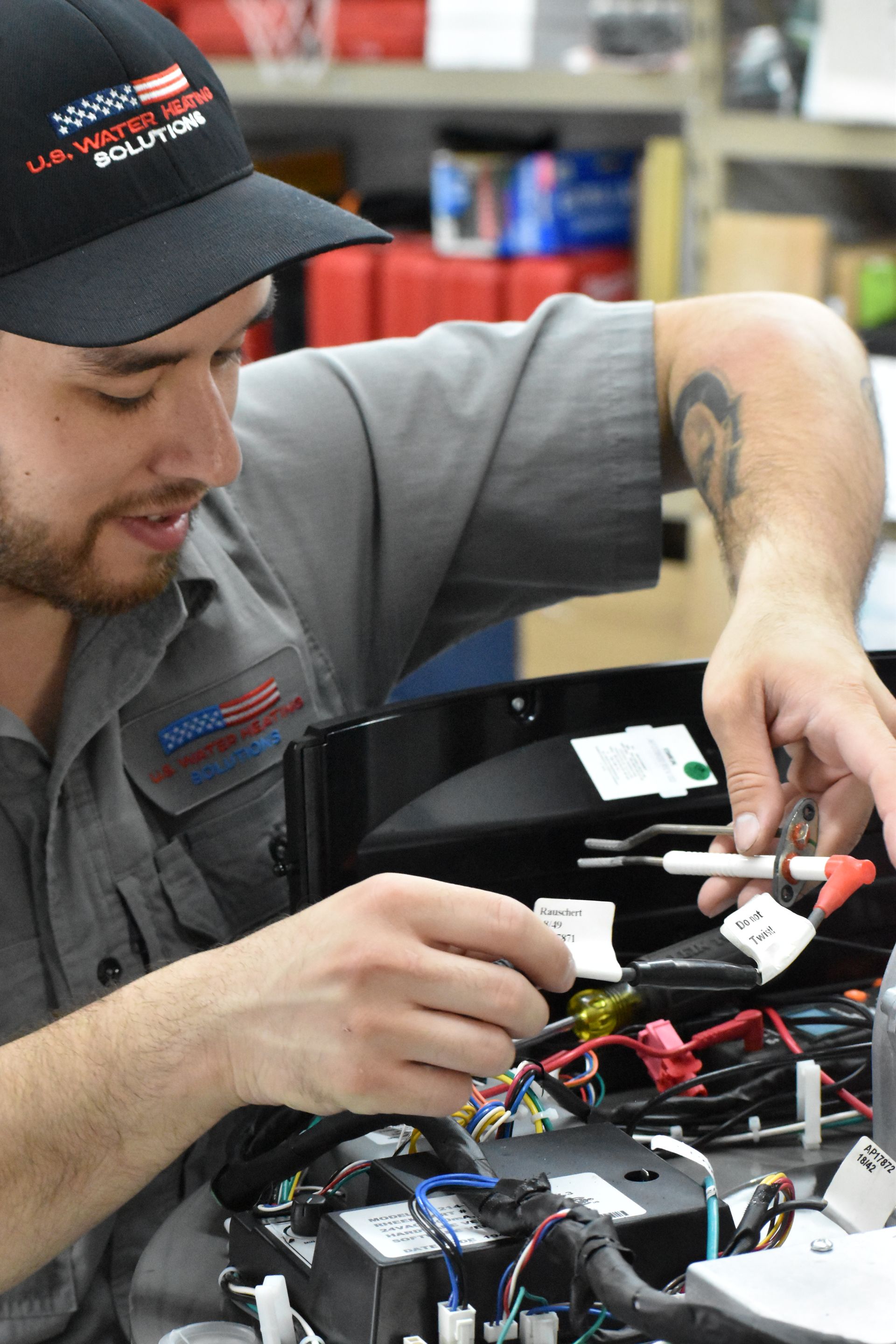 Technician diagnosing Rheem Triton commercial water heater