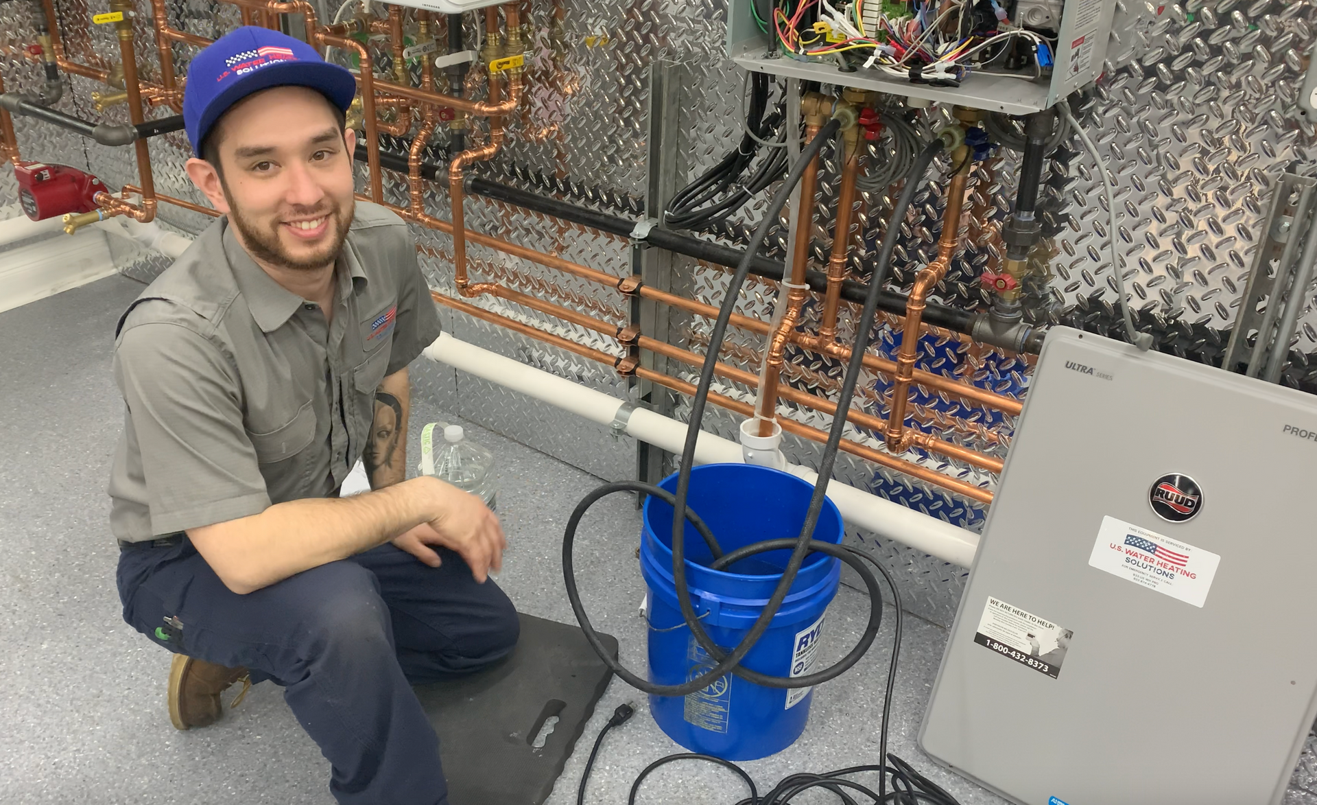Water heater technician performing flush on tankless water heater