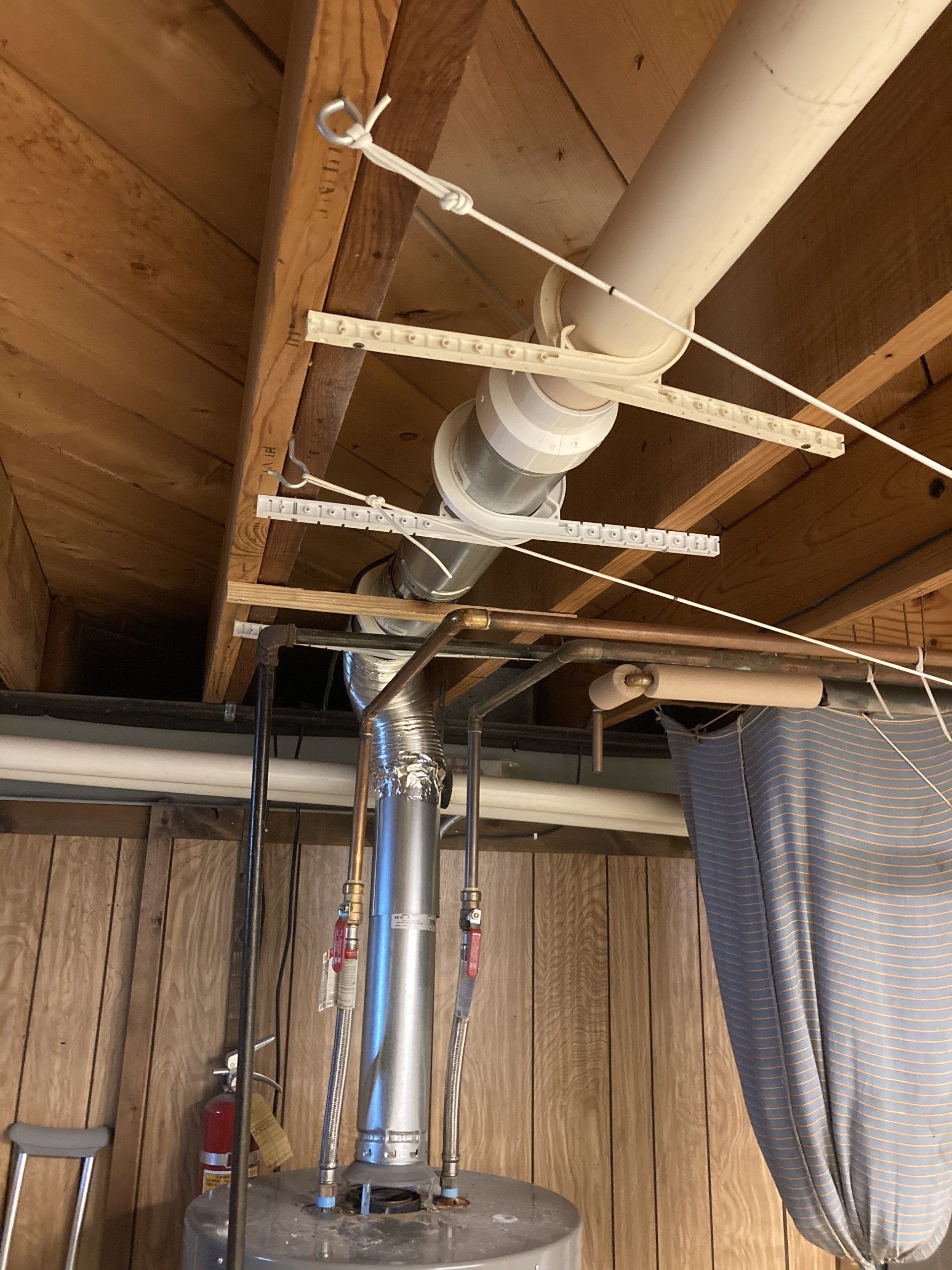 Example of poorly supported and improper water heater venting