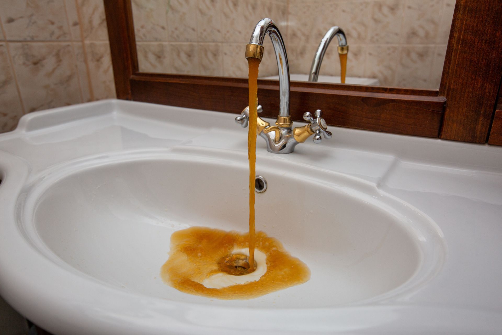 rusty water coming out of a bathroom faucet