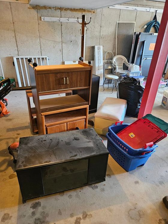 A garage filled with lots of furniture and boxes.