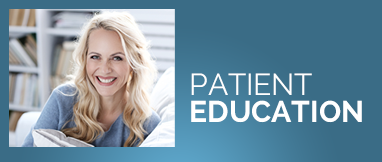 a woman is smiling in front of a sign that says patient education