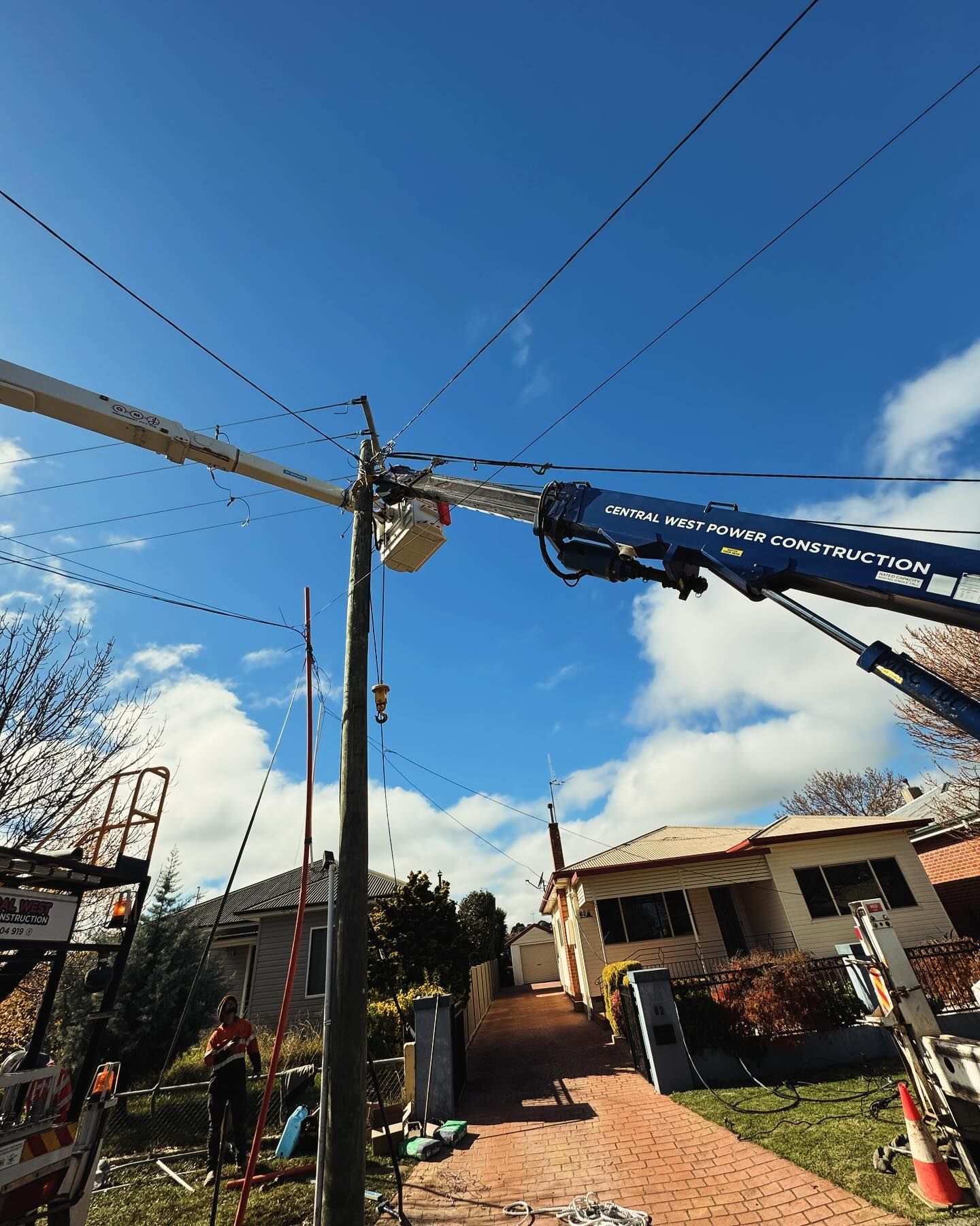 Electricians on a Lift Working on Power Lines Attached to a Pole — Central West Power Construction in Orange, NSW