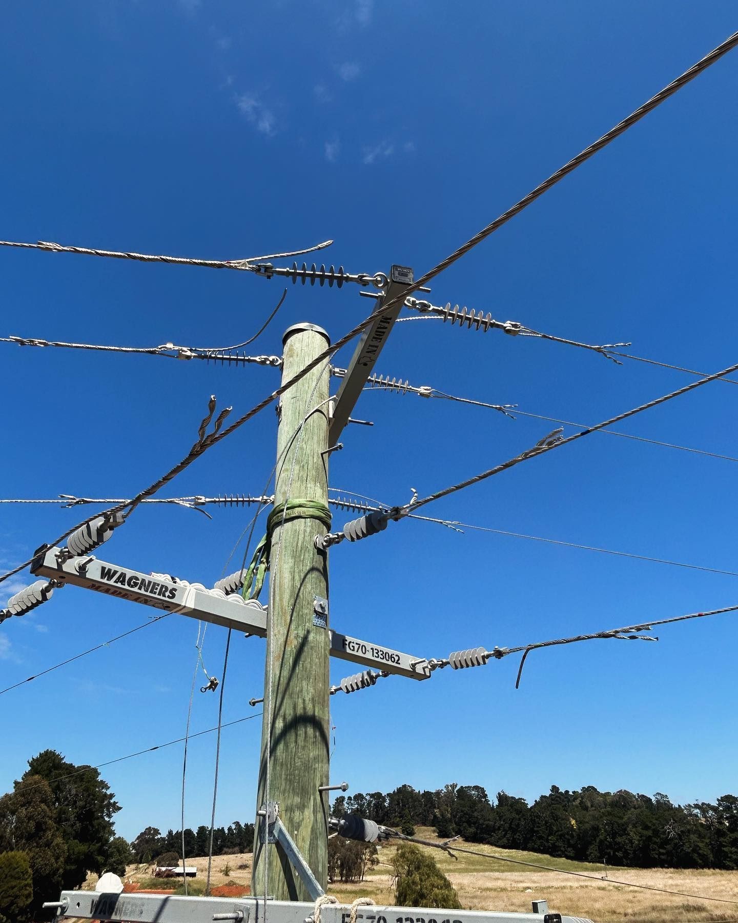 Wooden Utility Pole With Power Lines Against a Blue Sky — Central West Power Construction in Orange, NSW