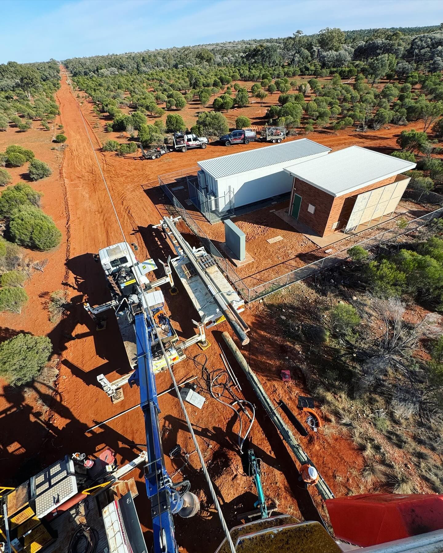 Truck With a Boom Lift Reaching for a Street Light Against a Blue Sky — Central West Power Construction in Orange, NSW