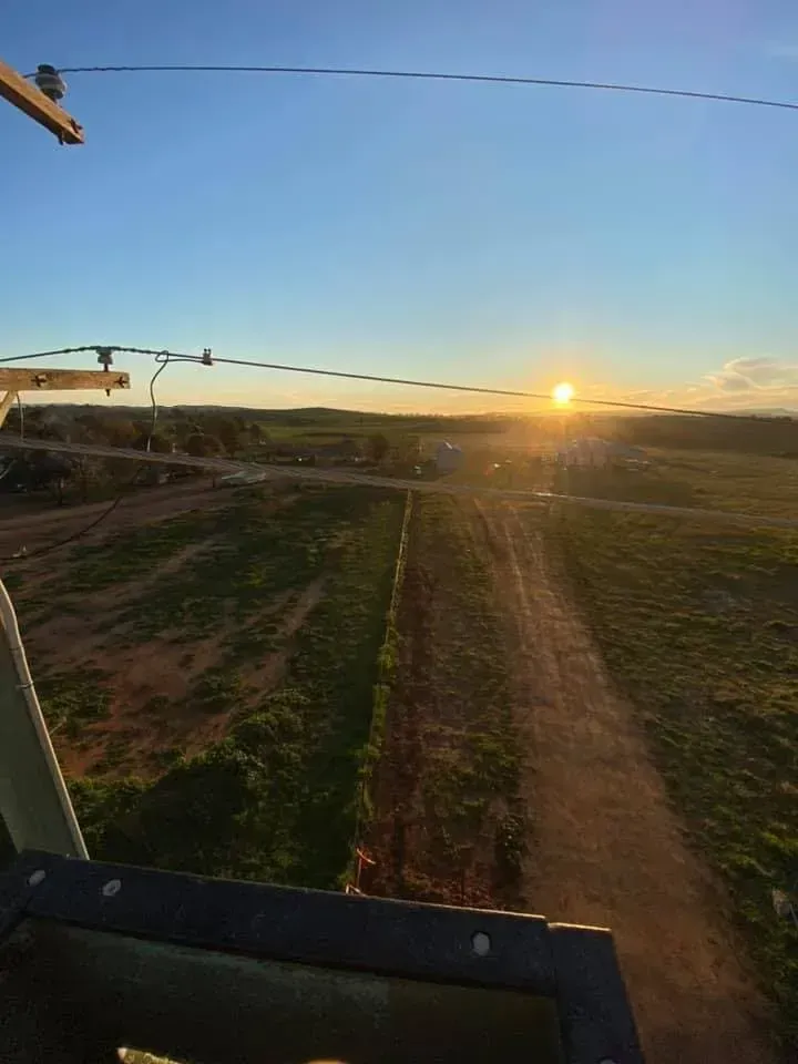 Sun Setting Over a Rural Landscape. Dirt Road Leads to the Horizon — Central West Power Construction in Orange, NSW