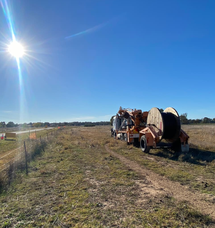 Linemen in Bucket Trucks Work on Power Lines Attached to a Utility Pole — Central West Power Construction in Orange, NSW