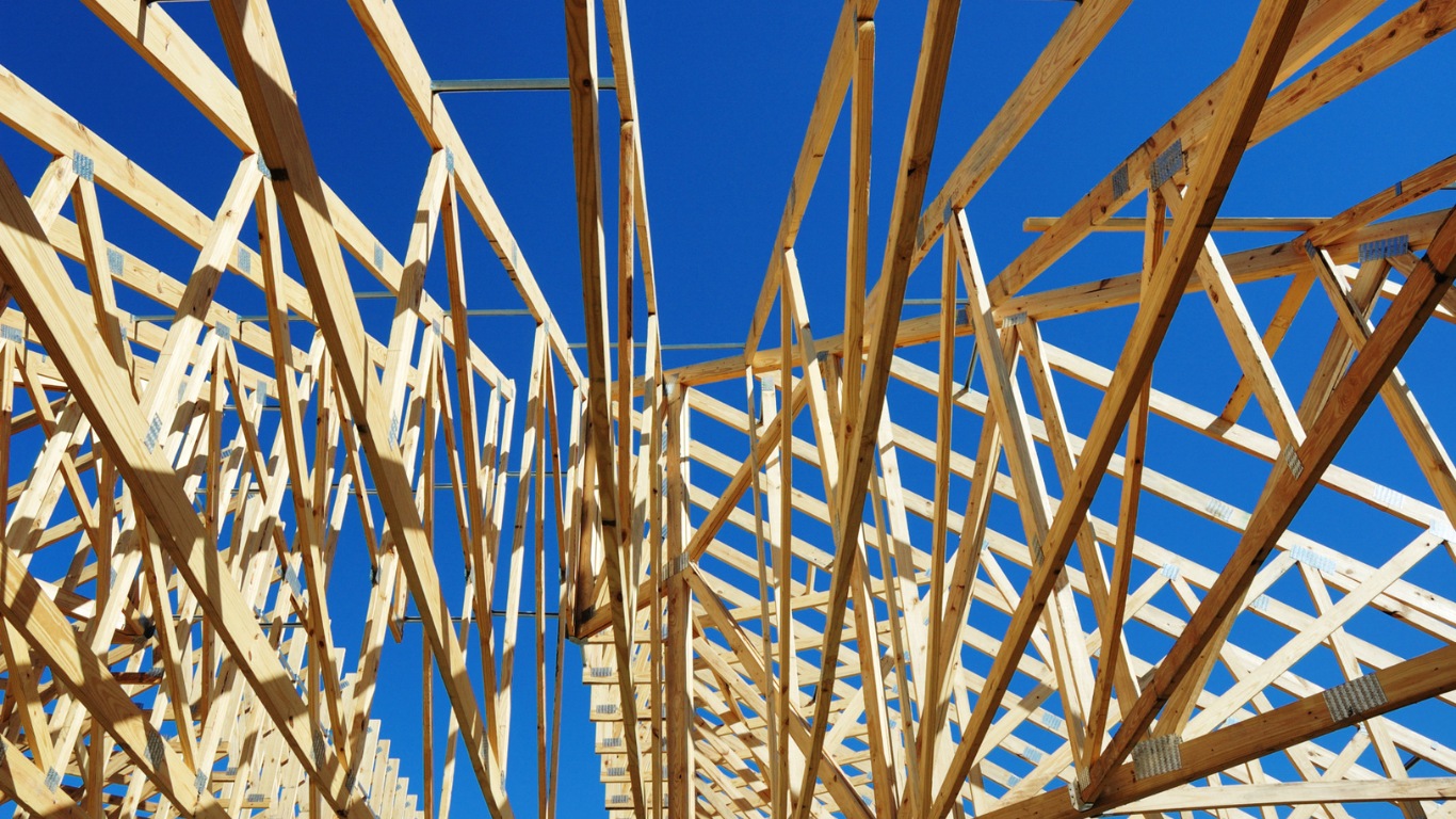 A house with a lot of windows and a wooden deck