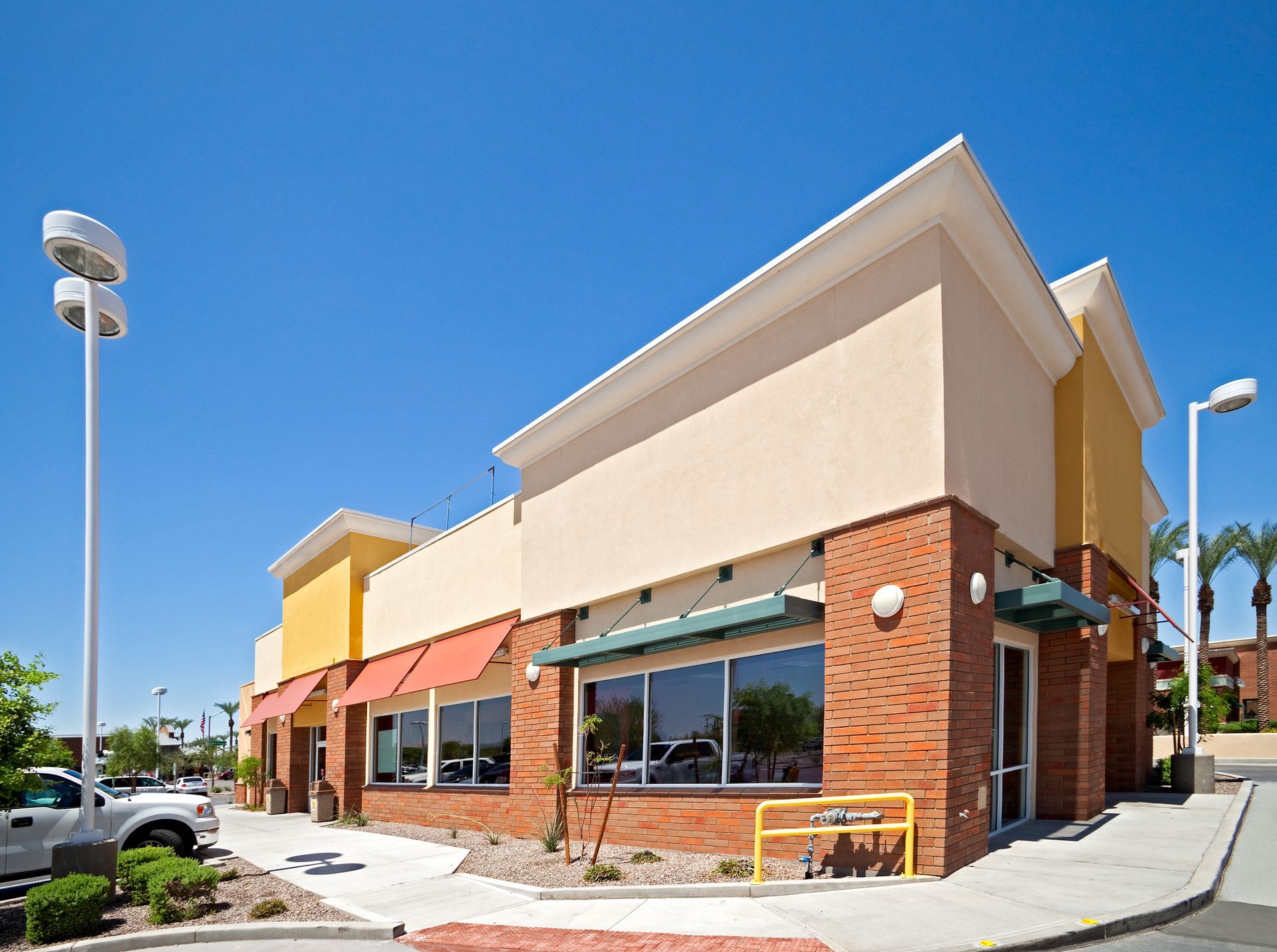 A man is laying shingles on a roof.