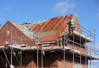 Picture of roofing contractors working on roof installation for a residential property.