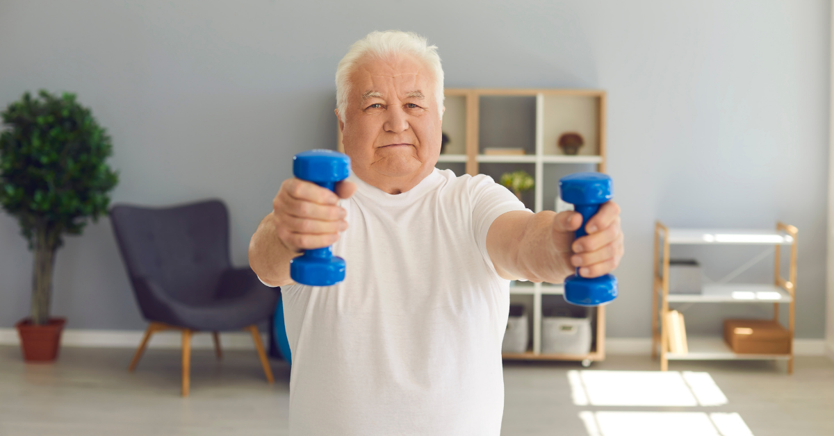 An elderly man with dumbbells in his hands